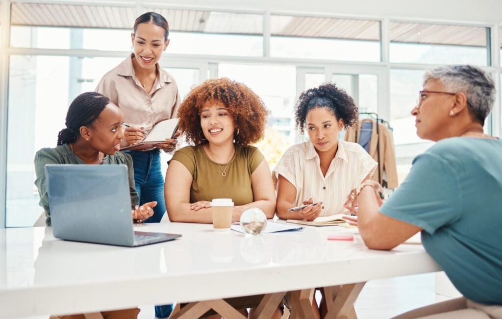 fashion designer and teamwork of women on laptop planning and brainstorming in startup office ta